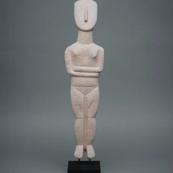 A reproduction late 20thC resin Cycladic female figure,